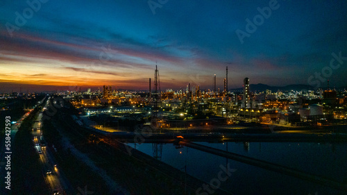 Oil and gas refinery plant or petrochemical industry on blue sky sunset background  Factory at twilight time  Gas furnace and smoke stack in petrochemical industrial