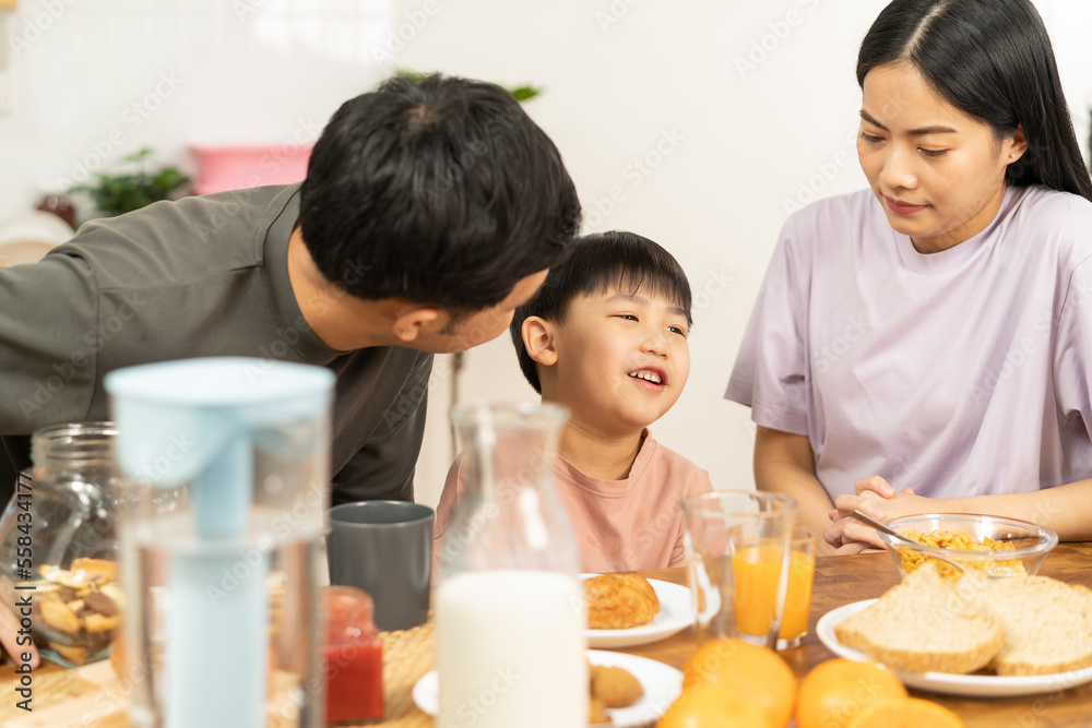 Happy refreshment family breakfast in morning, asian young parent father, mother and little cute boy, child having meal in kitchen eating together at home. Cheerful, enjoy cooking people. Happy refreshment family breakfast in morning, asian young parent father, mother and little cute boy, child having meal in kitchen eating together at home. Cheerful, enjoy cooking people.