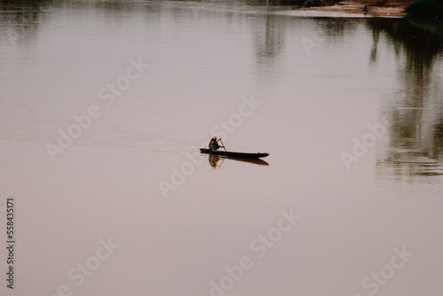 an old woman who uses a wooden boat on the Jambi 