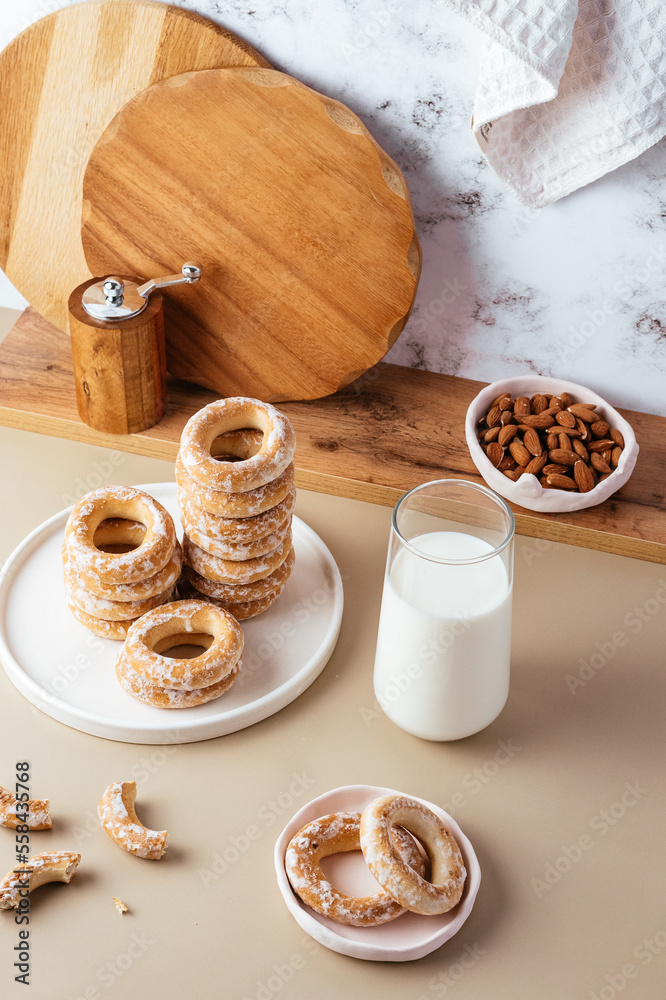 milk in a glass and bagels in glaze on the background of a marbl milk in a glass and bagels in glaze on the background of a marbl