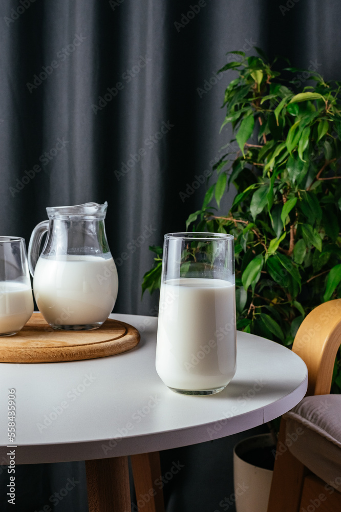 milk in a glass on a white table milk in a glass on a white table
