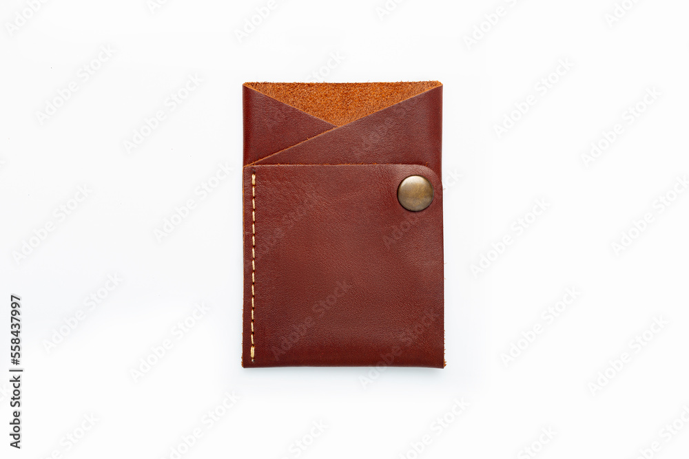 Brown leather wallet on a button on a white background. Card holder. Top view Brown leather wallet on a button on a white background. Card holder. Top view