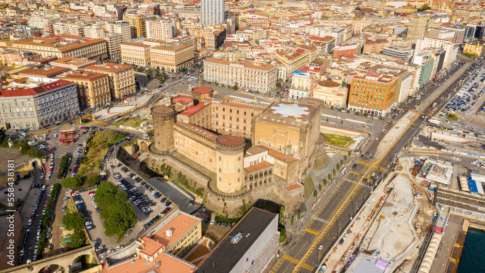 Obraz premium Aerial view of Castel Nuovo often called Maschio Angioino, a medieval castle located on the seafront, in the historic center of Naples, Italy. It was a royal seat for the kings of Naples and Aragon.