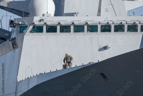 An armed soldier aboard an army warship. Security of army ships