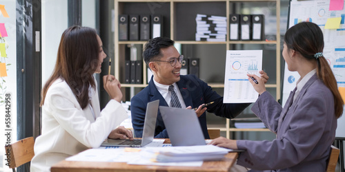 Group of young asian modern people in smart casual wear having a brainstorm meeting. Group of young asian business people discussing in the meeting.