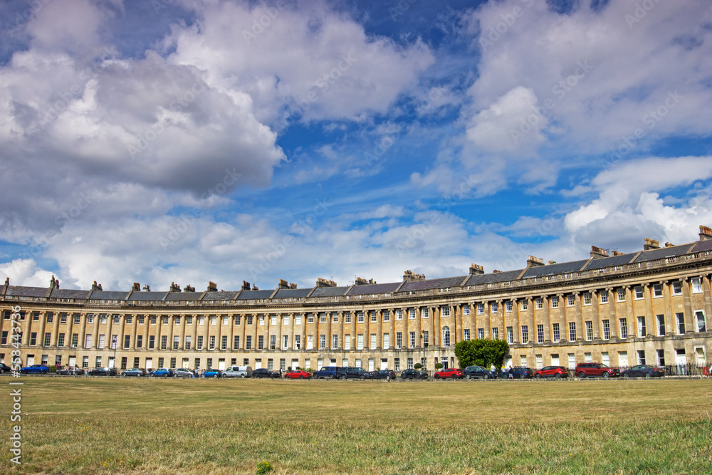 The listed Georgian Royal Crescent in Royal Bath Spa in England under blue skies