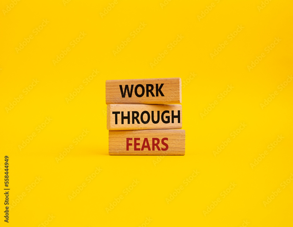 Naklejka premium Work through fears symbol. Wooden blocks with words Work through fears. Beautiful yellow background. Business and Work through fears concept. Copy space.