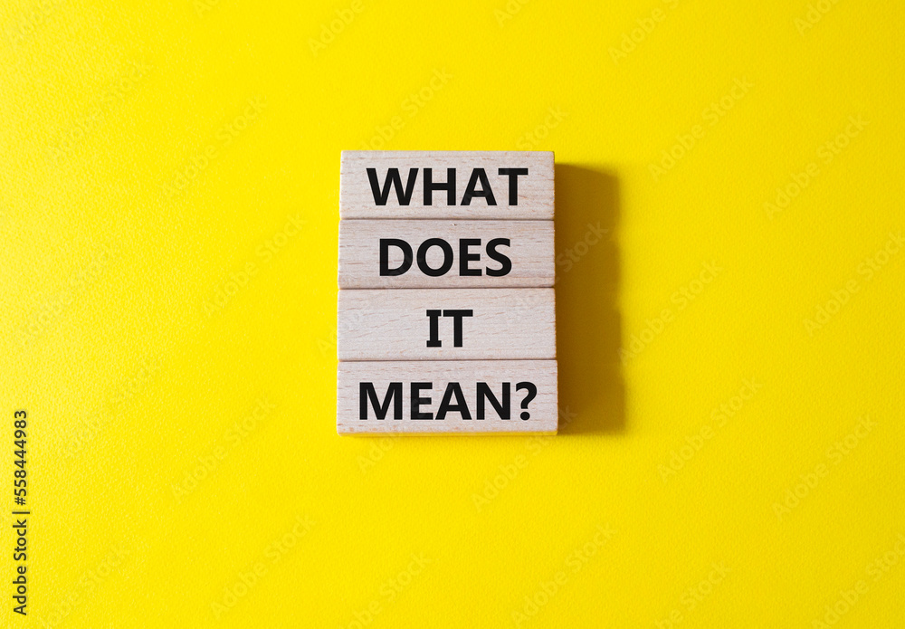 What does it mean symbol. Wooden blocks with words What does it mean. Beautiful yellow background. Business and What does it mean concept. Copy space.