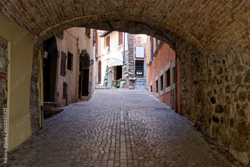 Fototapeta premium view through door with stone wall and path