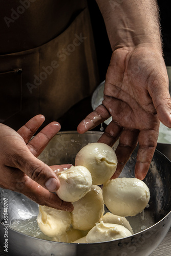 Traditional Cheesemaking, The processing Traditional Italian mozzarella, Cheesemaker, showing freshly made mozzarella