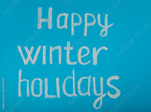 Chalk inscription HAPPY WINTER HOLIDAY or MERRY CHRISTMAS. Winter holidays. Celebration. Weekend.