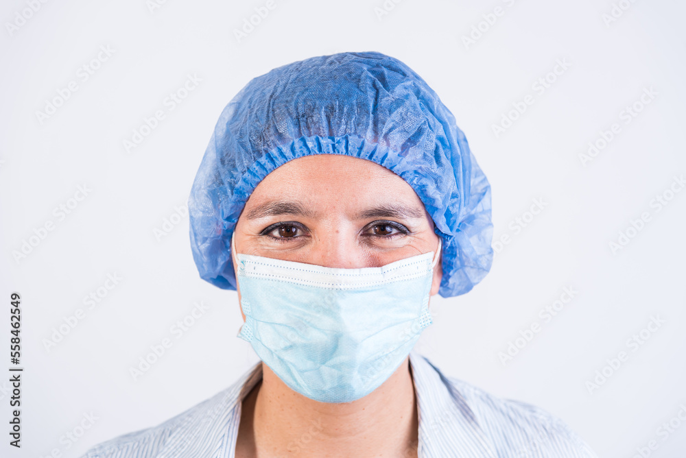 close-up of smiling doctor, with cap and mask, doctors investigating an infection. close-up of smiling doctor, with cap and mask, doctors investigating an infection.