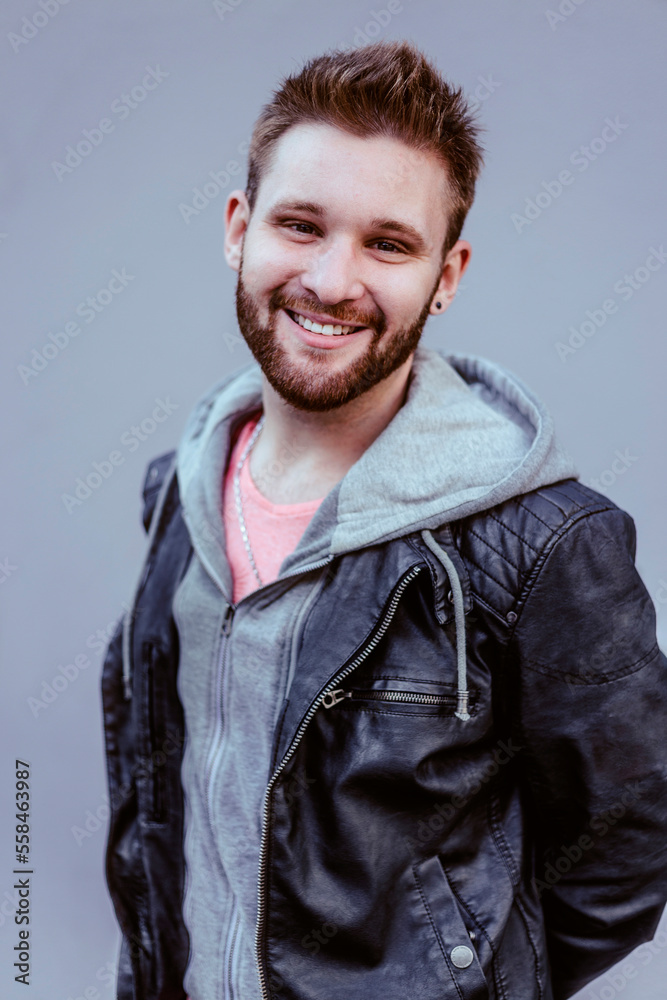 Smiling handsome man wearing casual clothing. Man hair style portrait. Male fashion model. Caucasian man with beard. Smiling handsome man wearing casual clothing. Man hair style portrait. Male fashion model. Caucasian man with beard.