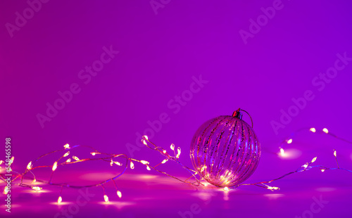 Christmas neon background with garland and Christmas ball, copy space. © sav_an_dreas