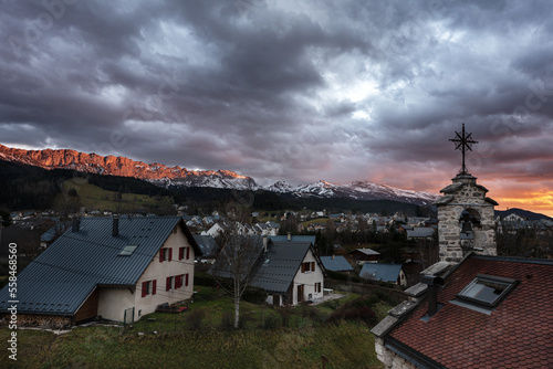 Reddish sunset on snow covered Vercors mountains at Villard-de-Lans village. France 2023