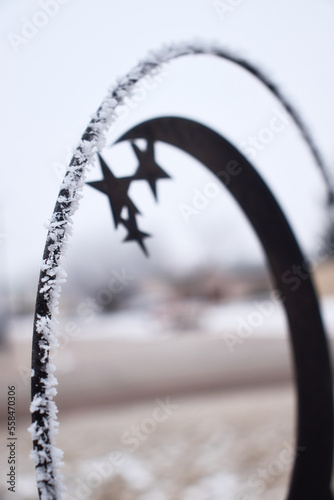 Ice crystals on a weather vane with stars in a yard in Gillette, Wyoming on a cold winterd day. photo