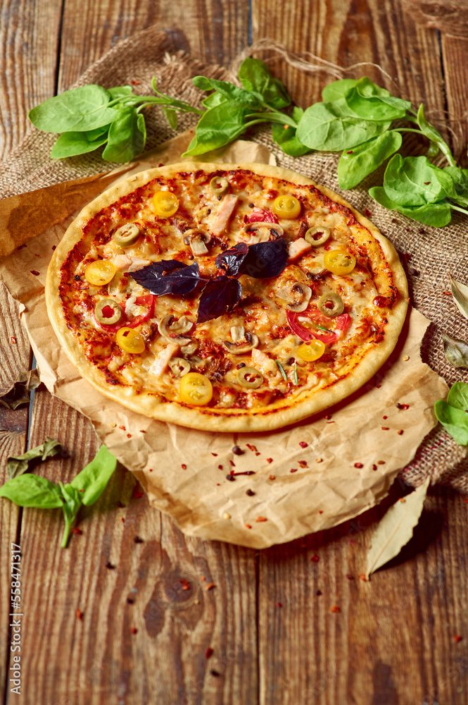 Delicious pizza served in country style with green salad ornament on wooden table with free space for text. Delicious pizza served in country style with green salad ornament on wooden table with free space for text.