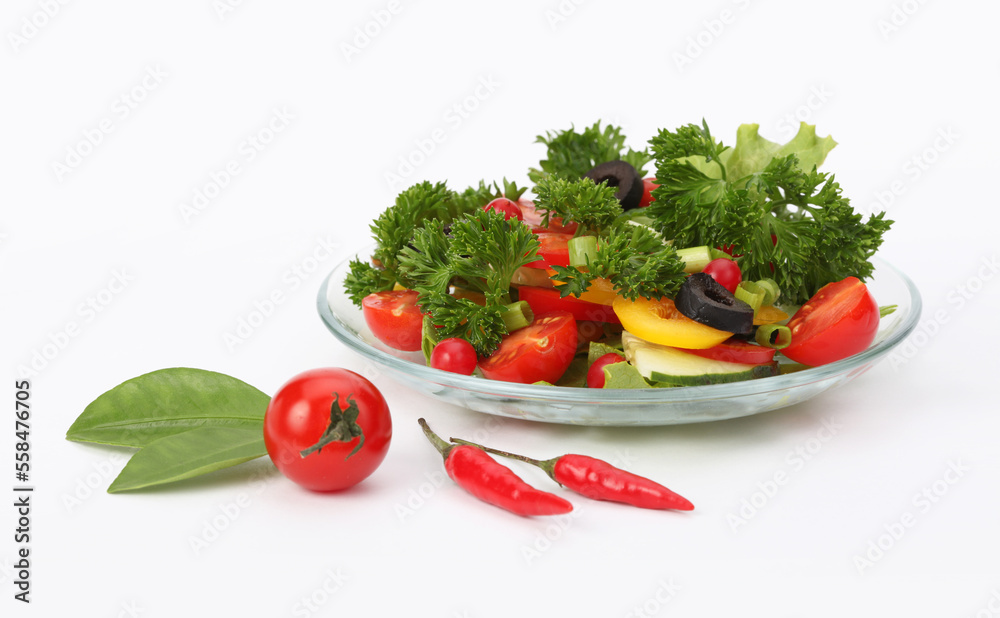 Tomato, cucumber, olives, parsley, pepper in salad on light background.