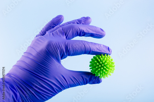 Doctor holding virus in hand. Medicine concept.