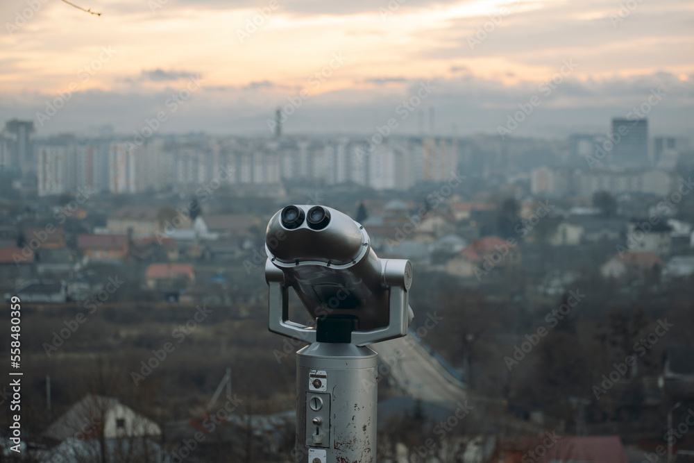 binoculars on the mountain with a beautiful view of the city panorama