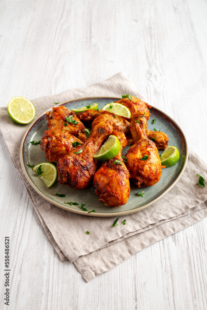 Homemade Grilled Jerk Chicken with Lime on a Plate, side view. Homemade Grilled Jerk Chicken with Lime on a Plate, side view.