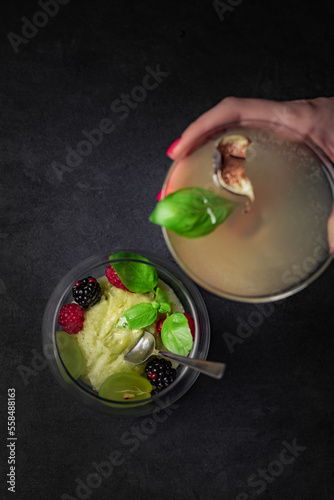 Delicious Spanish food, dishes on a dark background in a restaurant, tasty-looking dishes and drinks, colorful drink with fruit