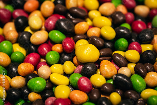 Candy background, peanuts covered with colorful chocolate, close-up.