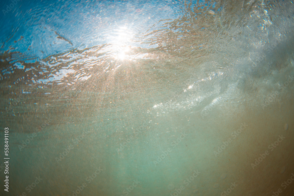 Sunlight piercing through the water surface.