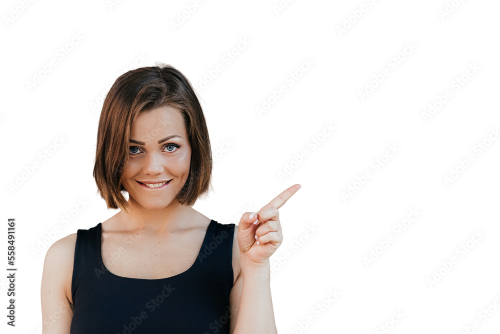 Happy fitness beautiful girl with short hair dressed casual, pointing at the free space with her index finger, looks satisfied over transparent background. Happy people concept Happy fitness beautiful girl with short hair dressed casual, pointing at the free space with her index finger, looks satisfied over transparent background. Happy people concept