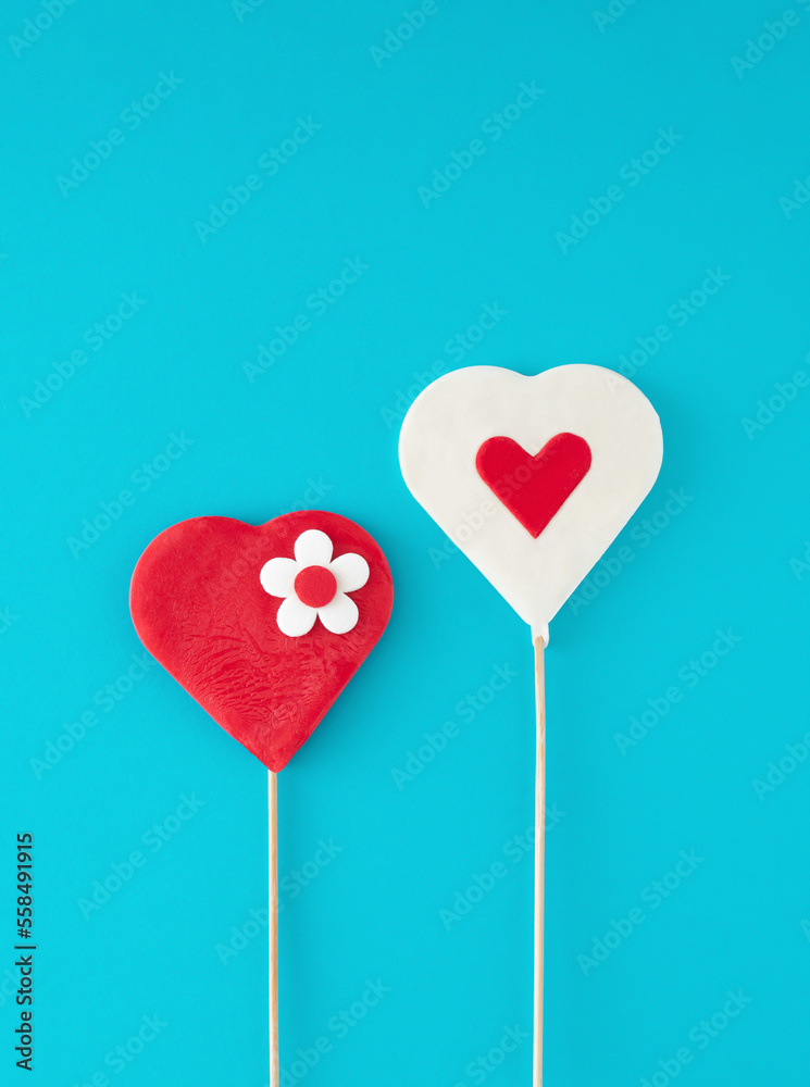 Creative testy heart lollipop composition on pastel blue background. Minimal love, concept. Valentine's day. Empty space.