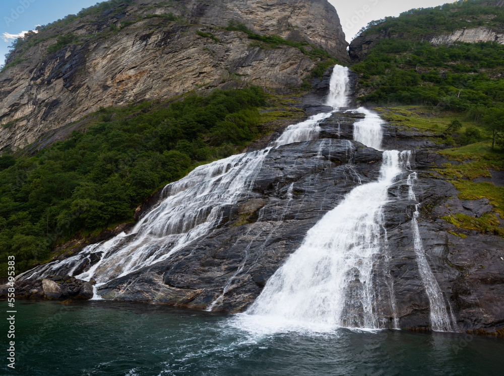 The famous and impressive waterfall The Suitor (Friaren) dropping down the rocks into the Geiranger Fjord, Norway