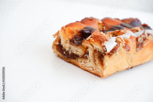Delicious cake with peanut butter cream layer and chocolate topping. Bakery white background. Selective focus