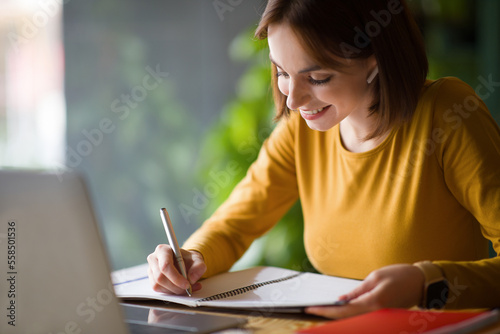 Closeup of pretty lady attending online training, cafe interior