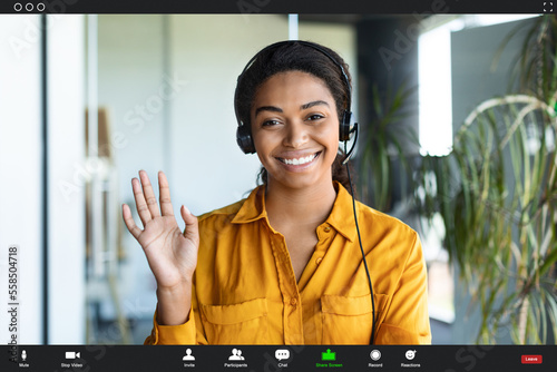 Bild auf Leinwand Positive african american businesswoman making video call from office, waving ha