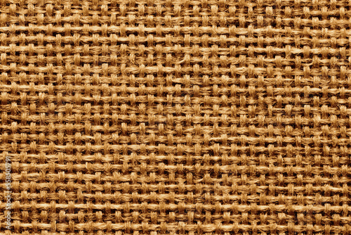 Natural brown linen fabric background. Fiber structure texture. Vintage canvas pattern.
