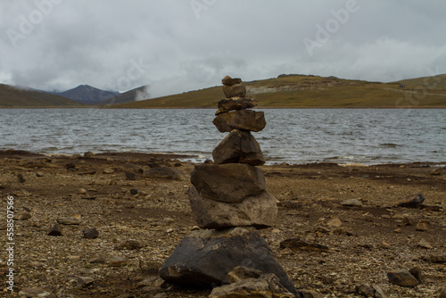 Landscape of the Andes of Peru in a lagoon with rocks piled up around it. Concept of nature and landscapes of South America. (Pomacocha, Perú) photo