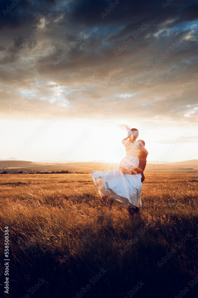 The bride and groom hold hands and look to the future in the middle of nature, the newlyweds walk together,wedding photography,until death do us part