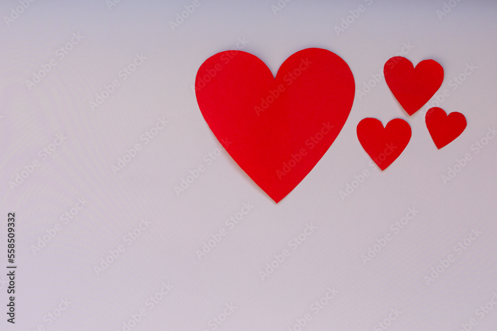 Paper craft hearts on a pink background top view. Valentine background with many red hearts. Flat lay