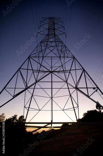 A power line tower in Claremont, Calif., is silhouetted against a sunset intensified in color by the nearby Station Fire. photo
