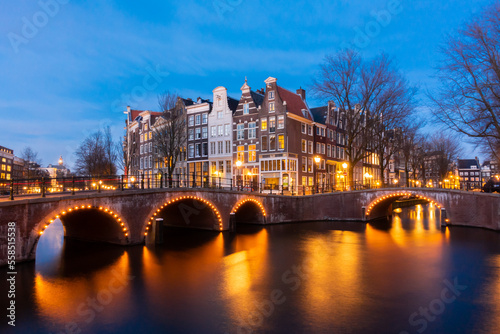 Amsterdam canal at twilight in winter  Amsterdam is the capital and most populous city in Netherlands.