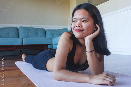 Young girl laying down on mat yoga after practicing yoga