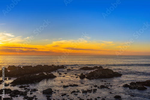 A wide view of a sunset of the Monterey Bay in California