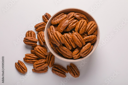 Tasty fresh ripe pecan nuts on white background, flat lay