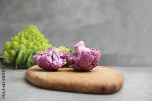 Fresh purple cauliflower on grey table, closeup