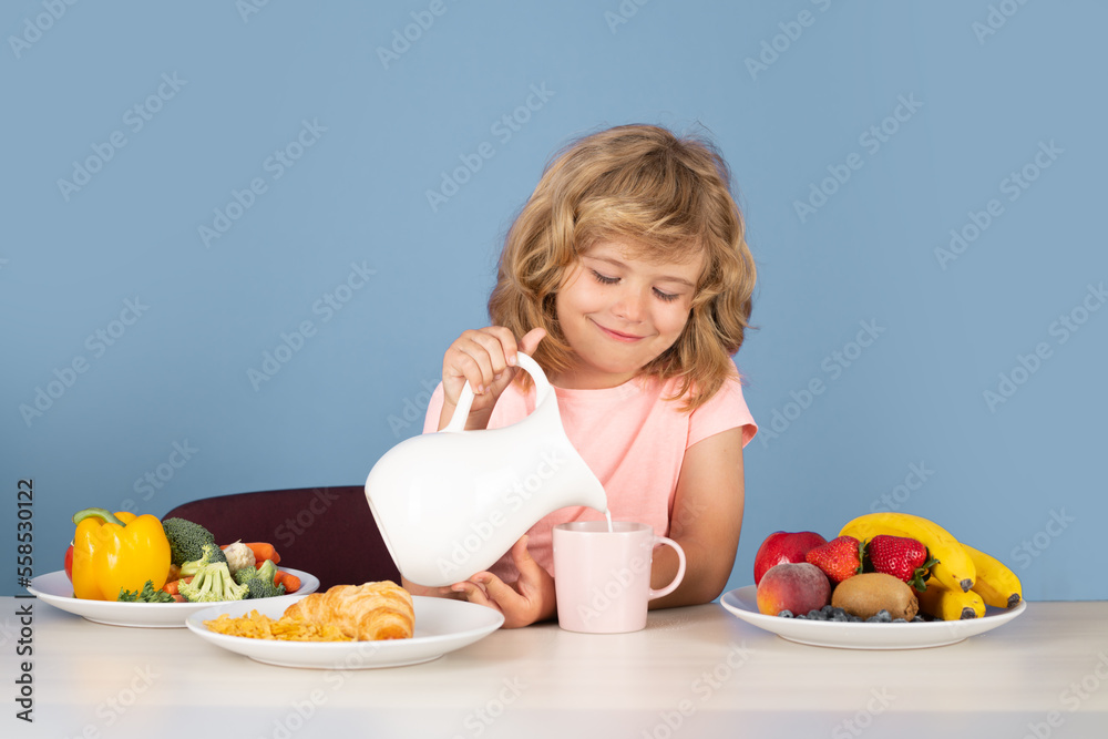 Kid with dairy milk. Kid boy pouring whole cows milk. Portrait of child eat fresh healthy food in kitchen at home. Kid boy eating breakfast before school. Kid with dairy milk. Kid boy pouring whole cows milk. Portrait of child eat fresh healthy food in kitchen at home. Kid boy eating breakfast before school.