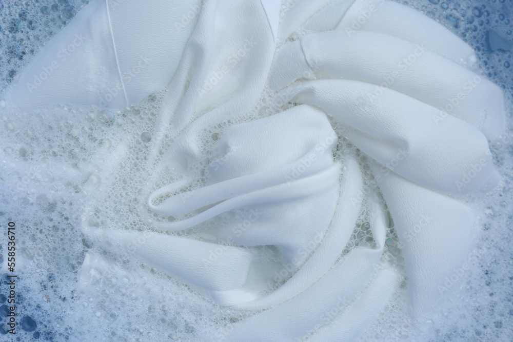 White clothing in suds, top view. Hand washing laundry White clothing in suds, top view. Hand washing laundry