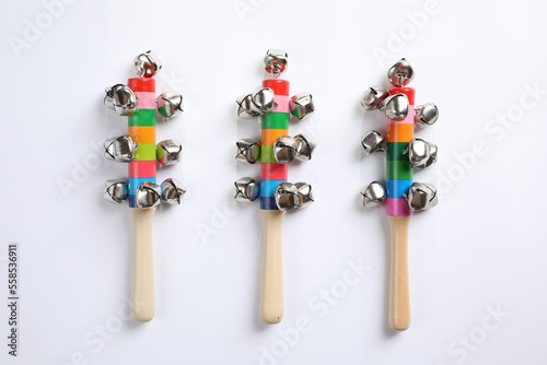 Wooden shakers with bells on white background, top view. Montessori musical toy
