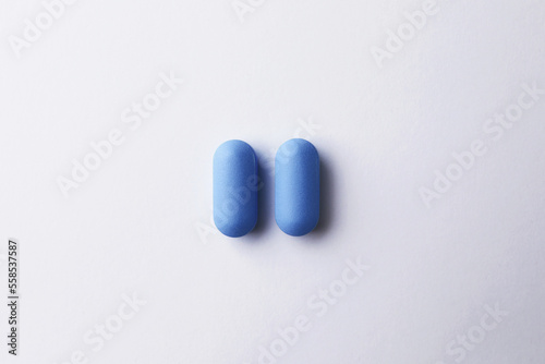 Pills on white background, top view. Potency problem