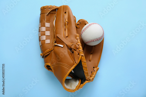 Catcher s mitt and baseball ball on light blue background  top view. Sports game