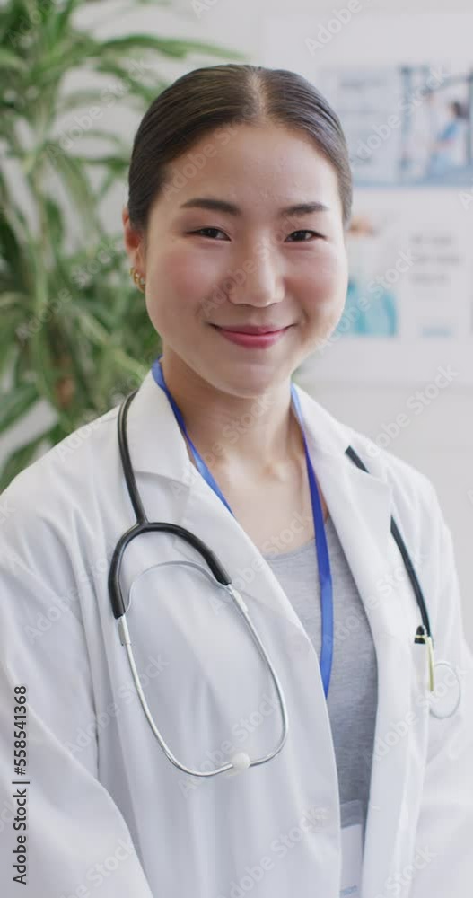Vertical video of portrait of happy asian female doctor Vertical video of portrait of happy asian female doctor